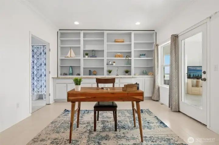 The library/office on the second floor has double pocket doors and plenty of storage.