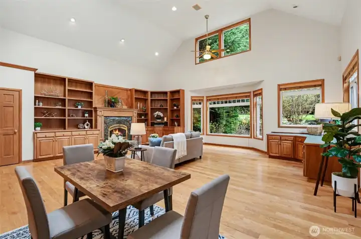 Soaring ceilings and expansive windows fill the home with natural light, creating an atmosphere that is both warm and refined in this great room.