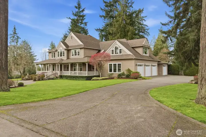 A circular drive leads toward the entrance. A side load 4 car garage provides ample parking.
