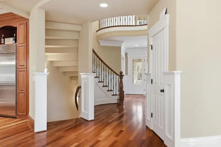 A curved stairwell off the kitchen leads to the lower level.