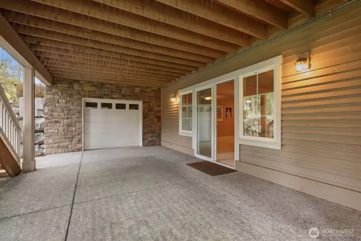 Lower level patio showing the garage entrance to the 1500 sq ft unfinished space.