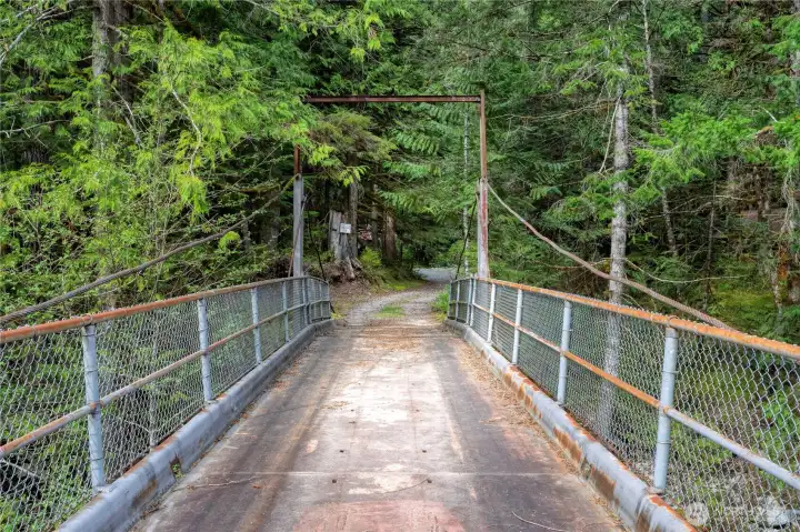 A one lane bridge over the river leads to your turn-key mountain escape.