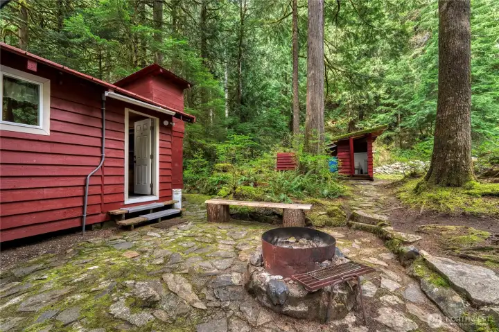 Property showcases extensive hardscape, two fire pits, ample seating and easy access to & from all structures.