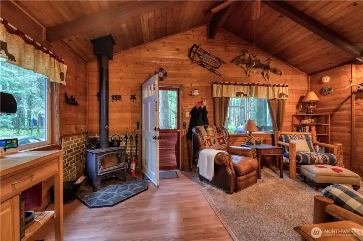 Step inside to rich wood walls & matching wood-plank ceiling that give the cabin its warm, timeless character ~ exactly what you dream of in a true woodland getaway! Loft access via ladder on opposite wall.