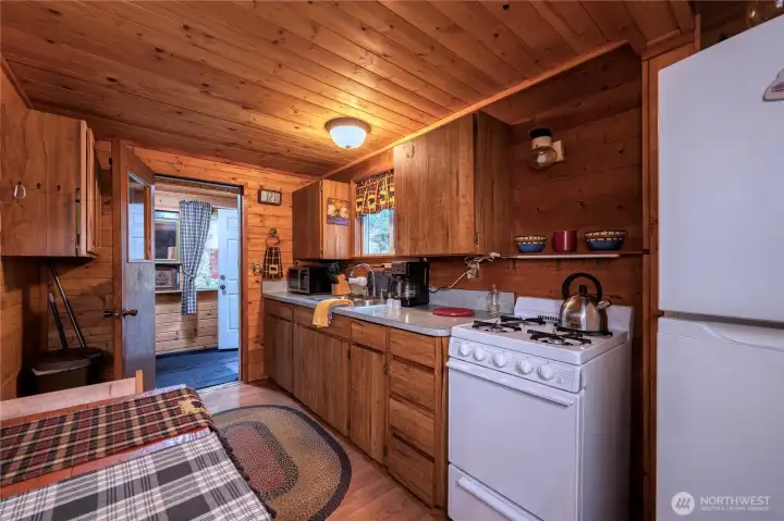 Fully equipped kitchen w/newer gas stove and dining setup. LED and propane lighting. And honestly, propane lights thru-out give the whole place that perfect old-school cabin vibe.