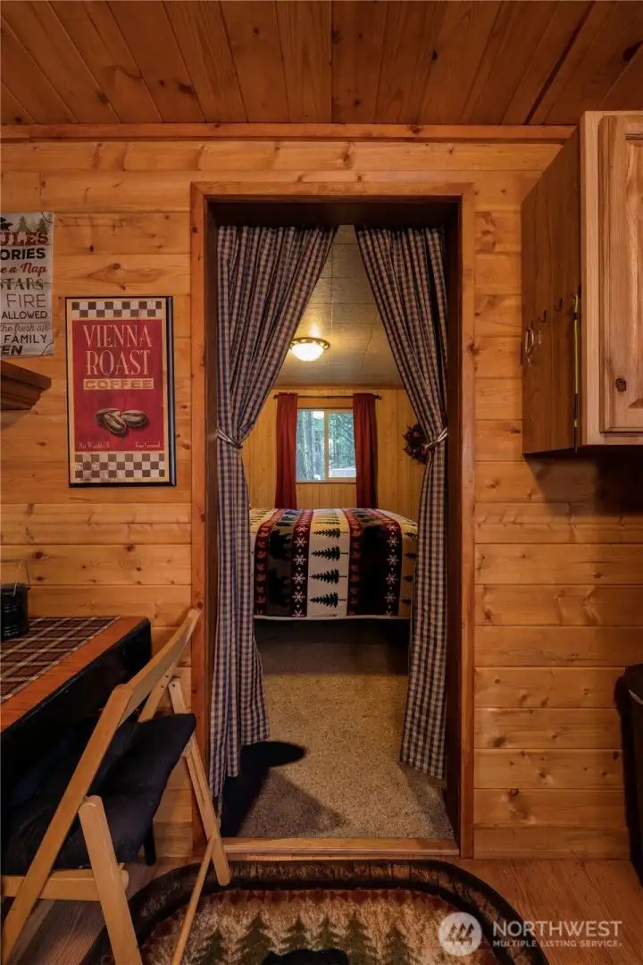 From the gingham curtains to the bear rugs and a mix of forest-inspired decor ~ every detail reinforces that timeless, rustic cabin charm.