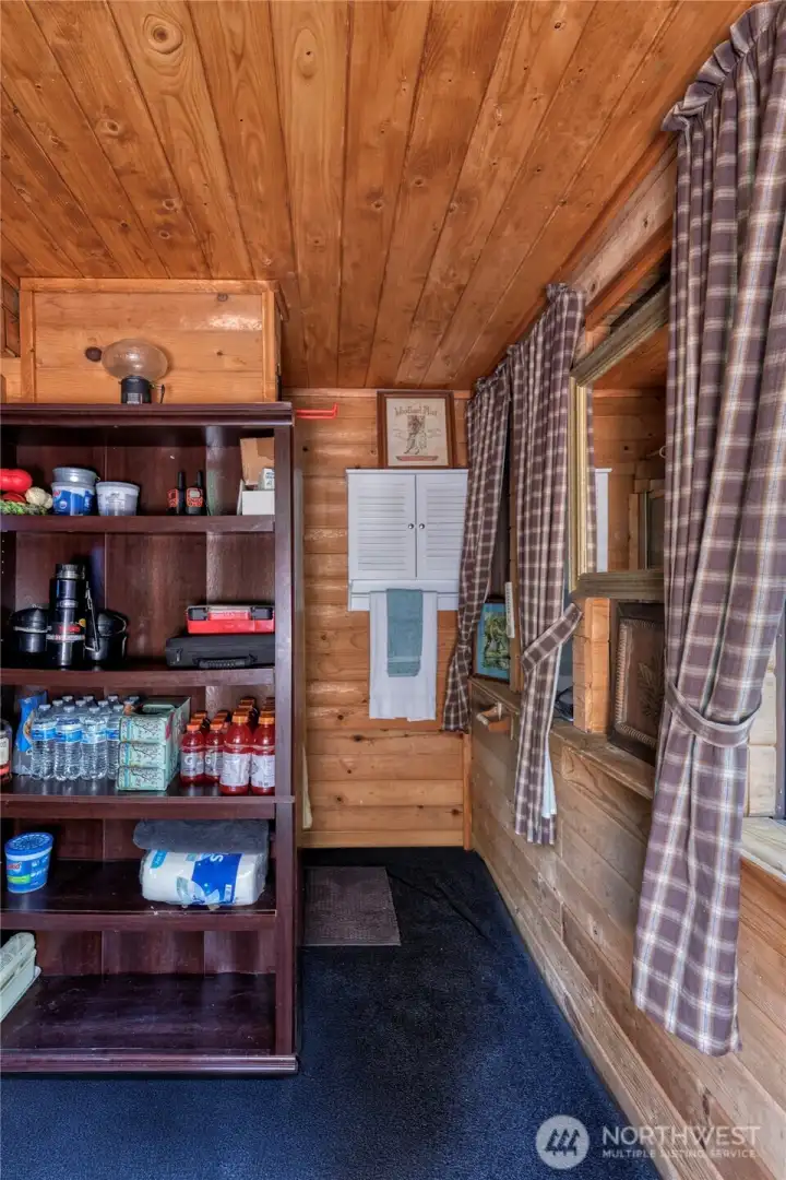 Shower with robust on-demand hot water situated behind handy storage cabinet.