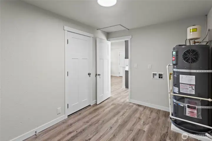 Laundry/mudroom right off the kitchen space with garage access.