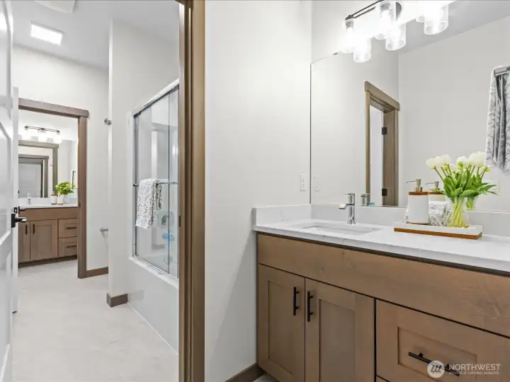 Jack and Jill Bathroom with each bedroom having it's own sink and built ins.