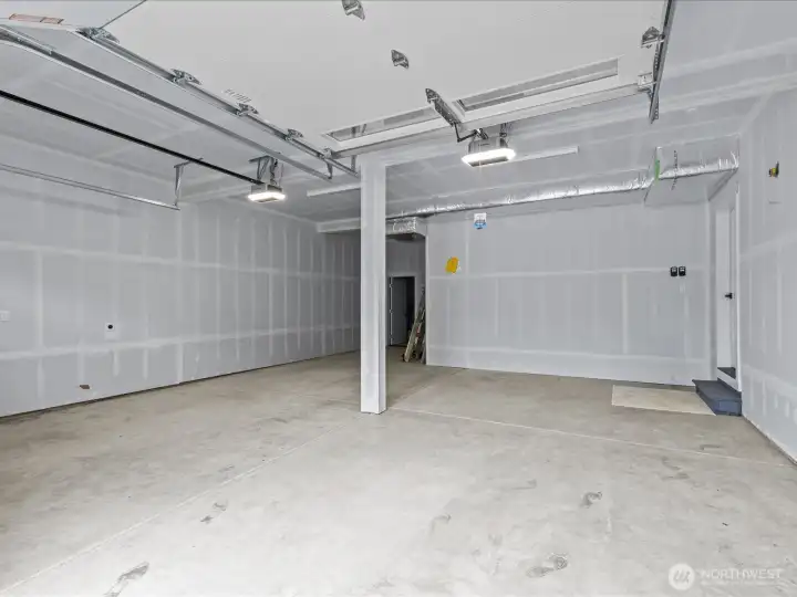 Extra large and deep garage. Could possibly hold 3 cars or use for extra storage or workbench.  EV charging outlet in the garage. Access to the backyard through the garage.