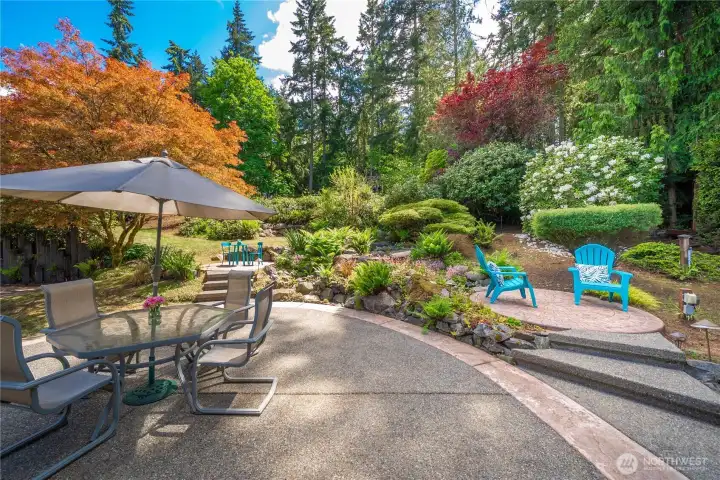 Expansive patio, Terraced back yard offering waterfalls, a large variety of plants and shrubs, level garden and play space, lighting and irrigation.