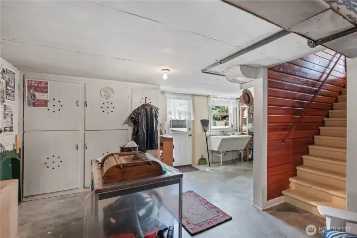 Loads of built-in cabinetry in the basement. Door leads to patio. Loads of built-in cabinetry in the basement. Door leads to patio.