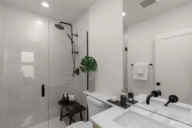 Elevate your routine in this unique bathroom with elegant green tiles and a modern vibe. It's all in the details!