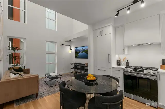 Experience seamless flow in this open-concept space, where modern black cabinetry meets inviting living areas, perfect for relaxing and entertaining.