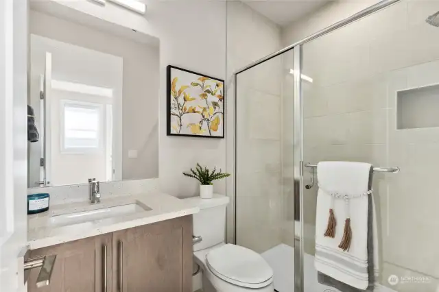 Lower level 3/4 bathroom with full height tile shower.