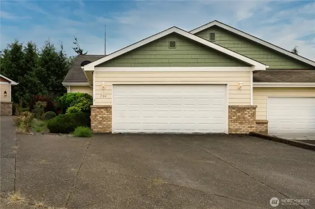 street view of large parking area and 2 car garage