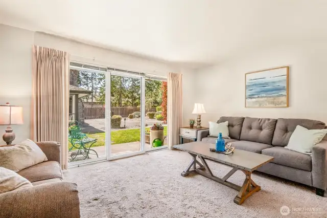Living room with view of patio, light and spacious