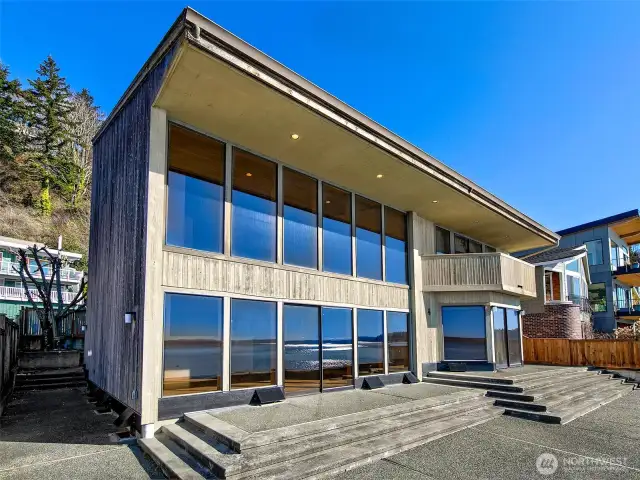Stunning custom home designed by renown architect, Philip Kallsan. Walls of windows onto Puget Sound.