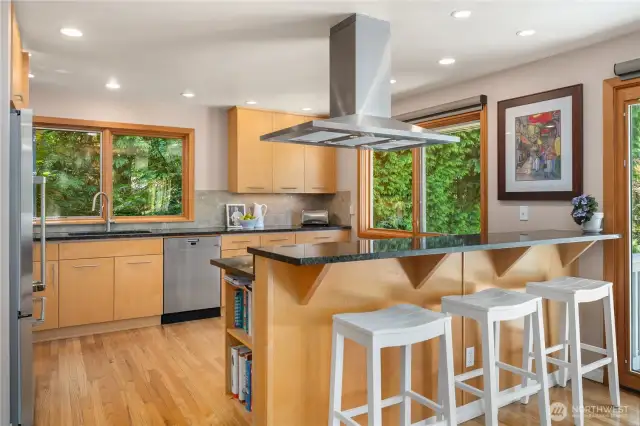 Updated kitchen with stainless appliances, newer cabinetry, and granite countertops