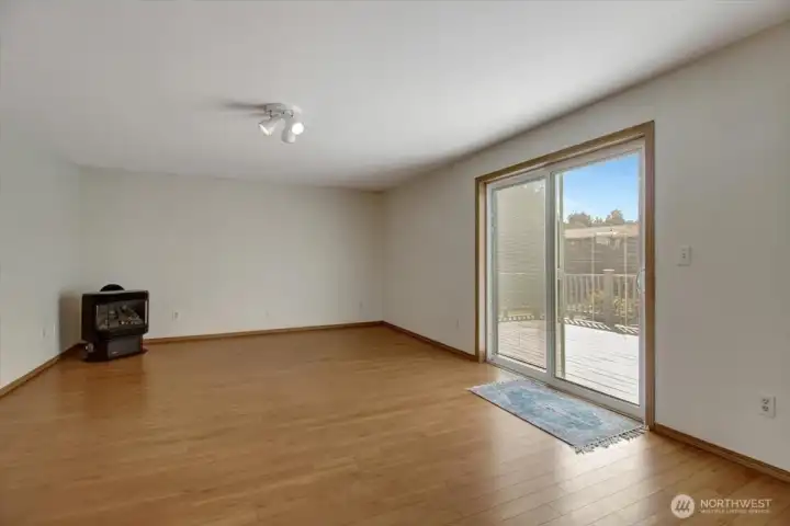 Family room with propane fireplace and slider out to the back deck.