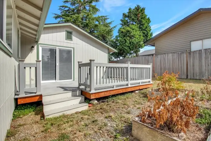 Sunny backyard is the perfect place for gardening or playing catch.