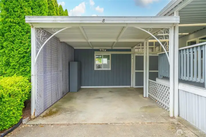 Carport offers parking for one vehicle covered, and another behind it in the driveway.