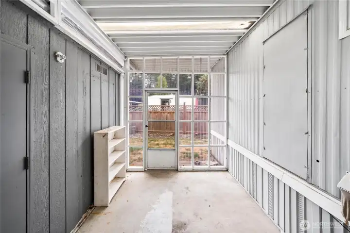 Sun room off the carport - storage or workshop on the left.