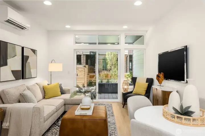 Open living room offering a natural gathering place for entertaining. Also includes easy access to the courtyard.