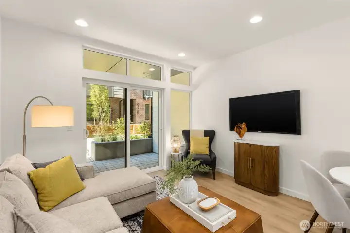 Expansive windows frame lush neighborhood views, creating a seamless indoor-outdoor feel that enhances every gathering.