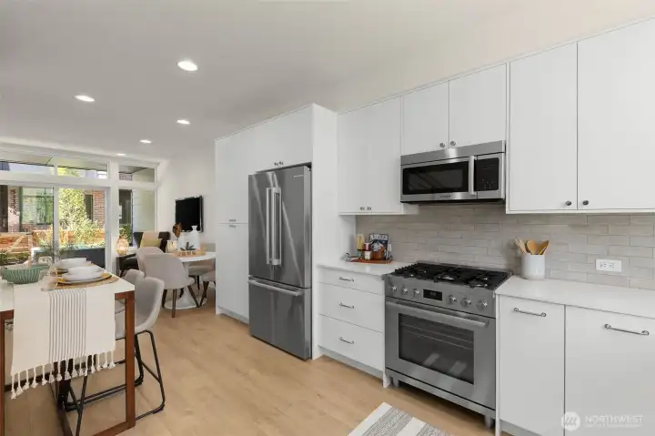 The chef-inspired kitchen features gas cooking, quartz counters, and sleek cabinetry designed for both style and function.