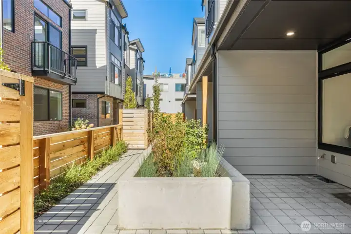 Fenced courtyard patio extending your living space outdoors — ideal for entertaining or quiet relaxation.
