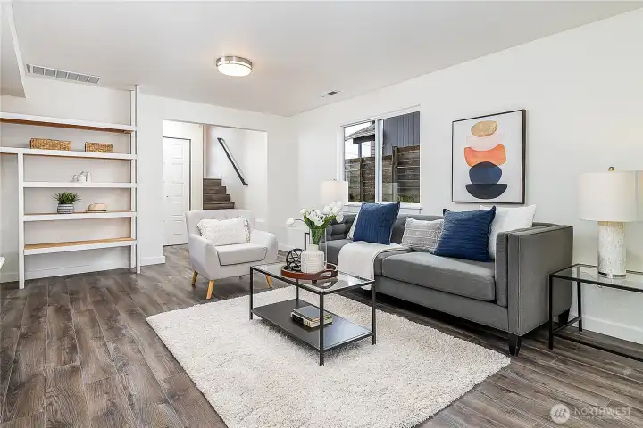 Connected to the family room on lower level is a full bath + laundry room with extra storage, in addition to the office with tri-fold slider doors & 2 more bedrooms (not pictured: door to garage to left of base of stairs).