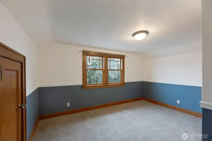 The upper bedroom is spacious enough to fit a queen bed! And the deep closet and built-ins make for great storage!