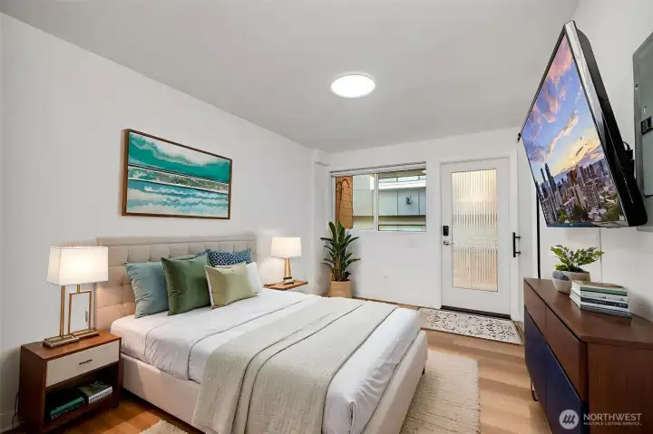 Flexible lower-level bedroom with natural light and direct exterior access. Ideal for guests, remote work, or private retreat space. (Virtually staged)