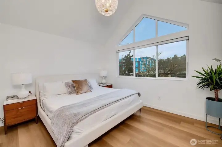 Top-floor primary suite with vaulted ceilings and oversized windows. Calm, private, and light-filled.