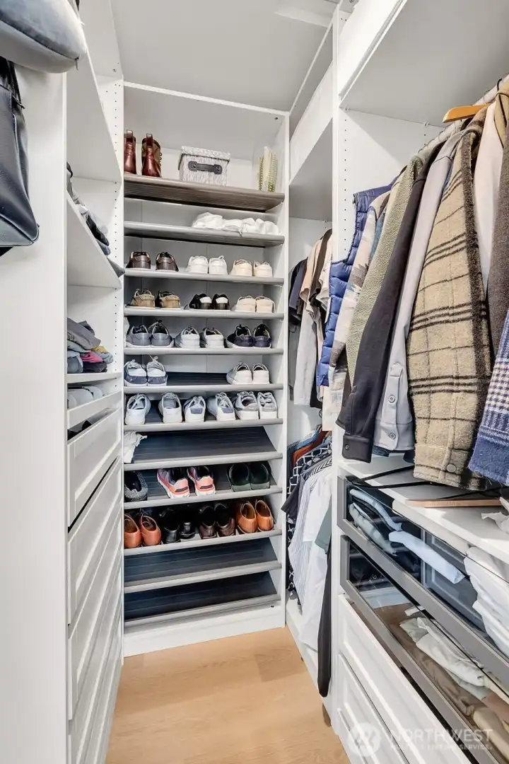 Generous walk-in closet with built-in shelving and drawers. Designed for real storage, not wasted space.