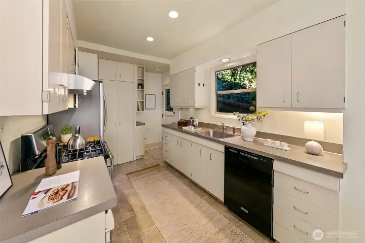 The bright kitchen has great storage space in ample cabinetry, Samsung gas range and French door style refrigerator, and KitchenAid dishwasher.
