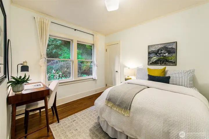 The NW bedroom has a serene outlook to the back yard and patio.