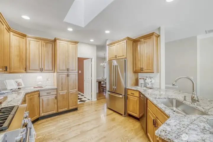Kitchen with Wolf range, JennAir refrigerator and a Miele dishwasher