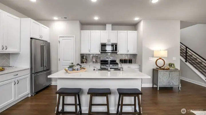 Deep farmhouse kitchen sink and plenty of seating in this large kitchen island