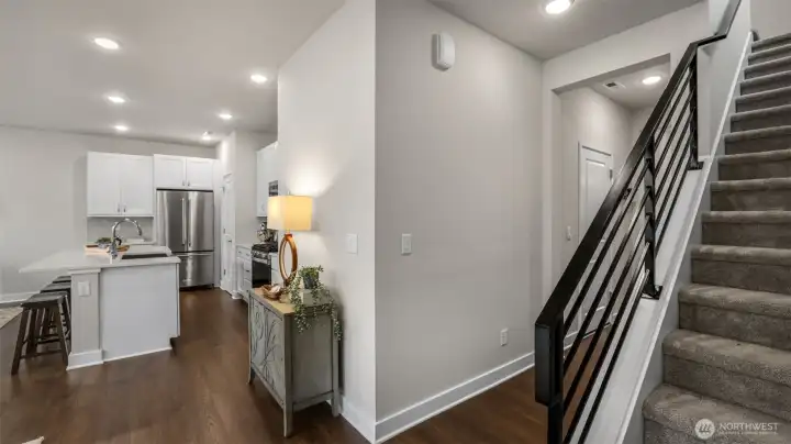 Beautiful laminate hardwood transitions to sound absorbing stairway carpet