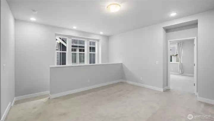 At the top of the stairs is a versatile large bonus room/loft