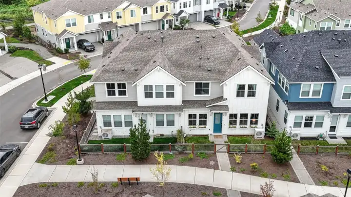 Fenced front yard ideal for pets and gardening leads to community walking trails