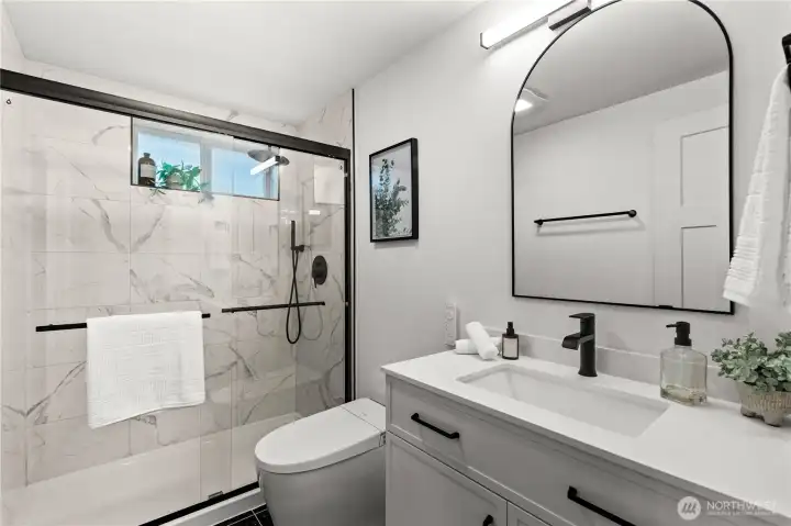 Brand new primary bathroom featuring a bidet toilet with a remote