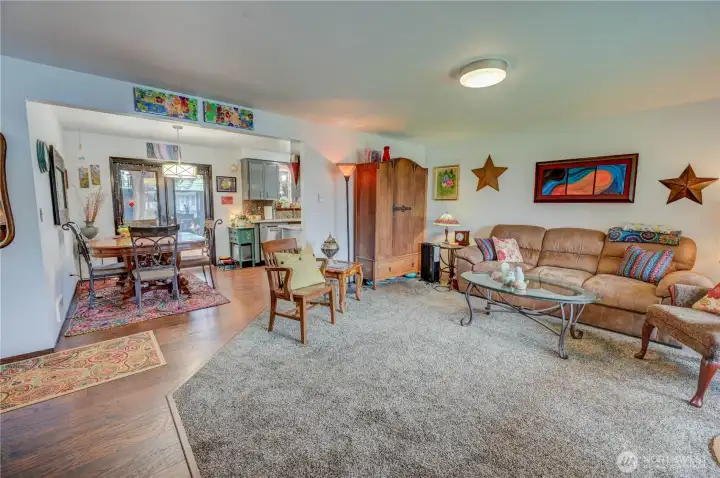 Entry into unit leads you into the carpeted living room with LVP walkway to the dining area and kitchen and hallway to bedrooms and bathroom wing.