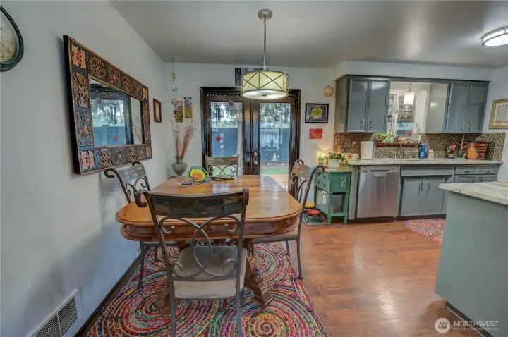 Dining room space off kitchen with french doors leading out to backyard