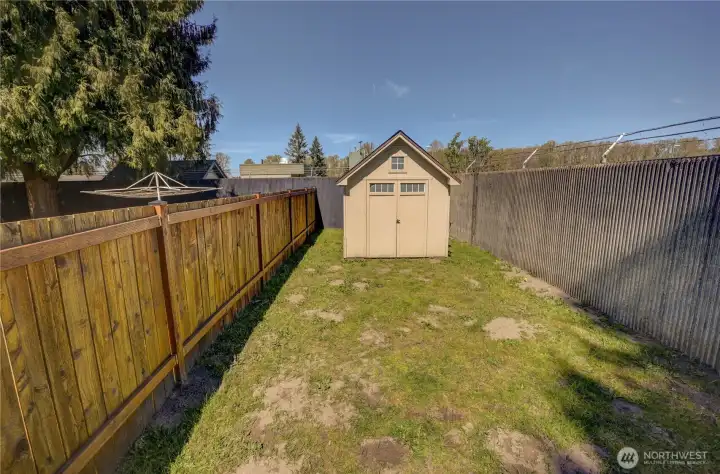 Dog run/side yard space with outbuilding on right side unit