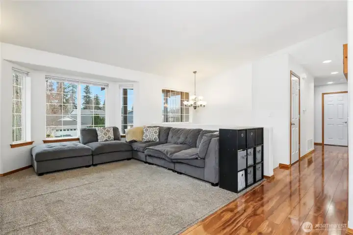 From this angle you can see the beautiful laminated hardwoods leading down the hallway to beds and baths.