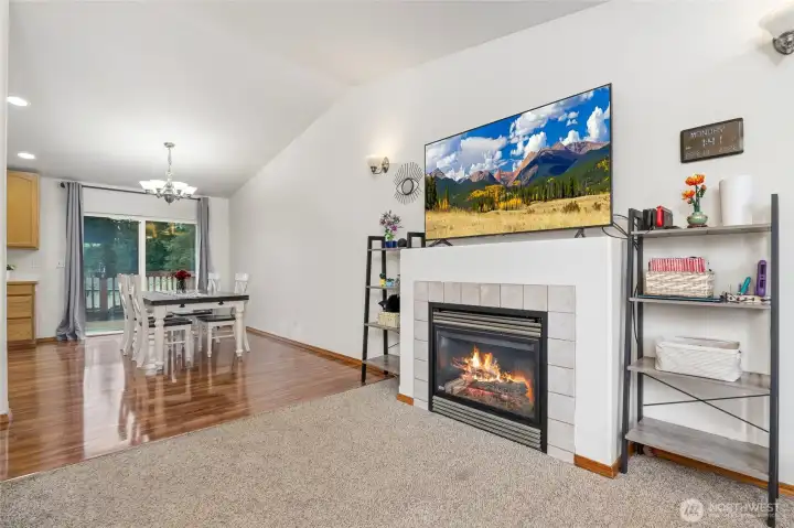 Open living and dining spaces are perfect for family gatherings. The slider leads out to the deck, ideal for barbecues and watching backyard activities.