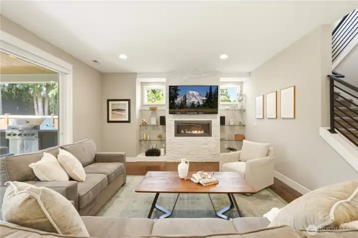 Gleaming floors, a gas fireplace, and a 65" TV included - this living room is ready to enjoy from day one.